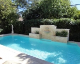 Geometric pool with fountain and raised wall