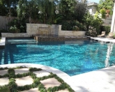 Geometric pool with raised spa and pool landscaping