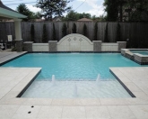 Geometric pool with raised wall and bubblers