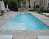 Geometric pool with tanning shelf and custom coping