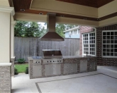 Outdoor Kitchen with stainless steel cabinets & commercial hood