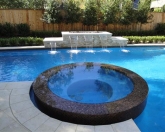 Raised custom tile spa and sheer descents